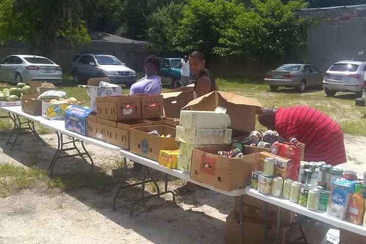 Dream Builders Mission volunteers handing out boxes of food at an early outdoor distribution in Tampa